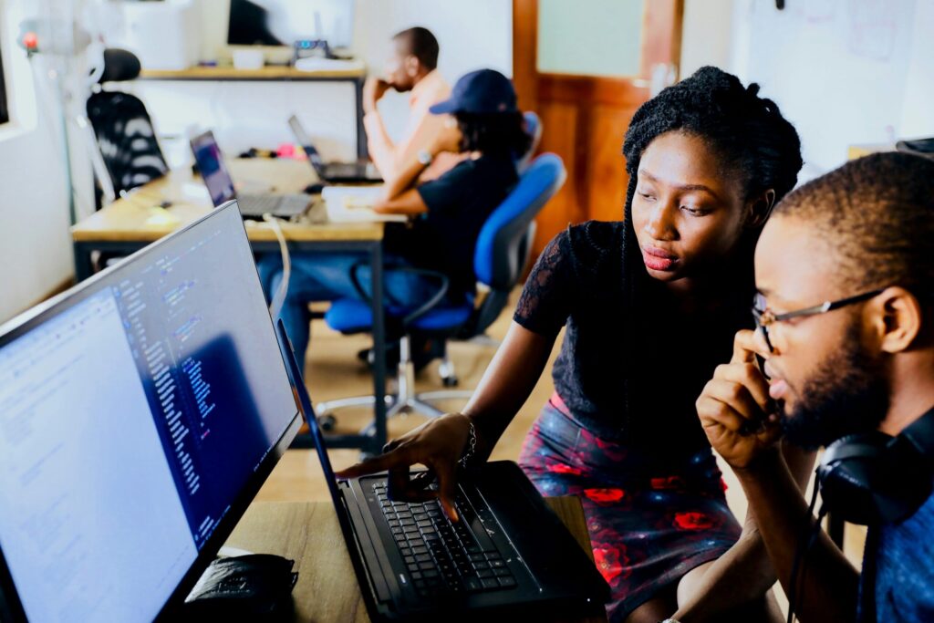 Two colleagues working at a computer together